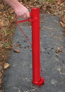 Poke handheld planter into soil Poke handheld planter into soil